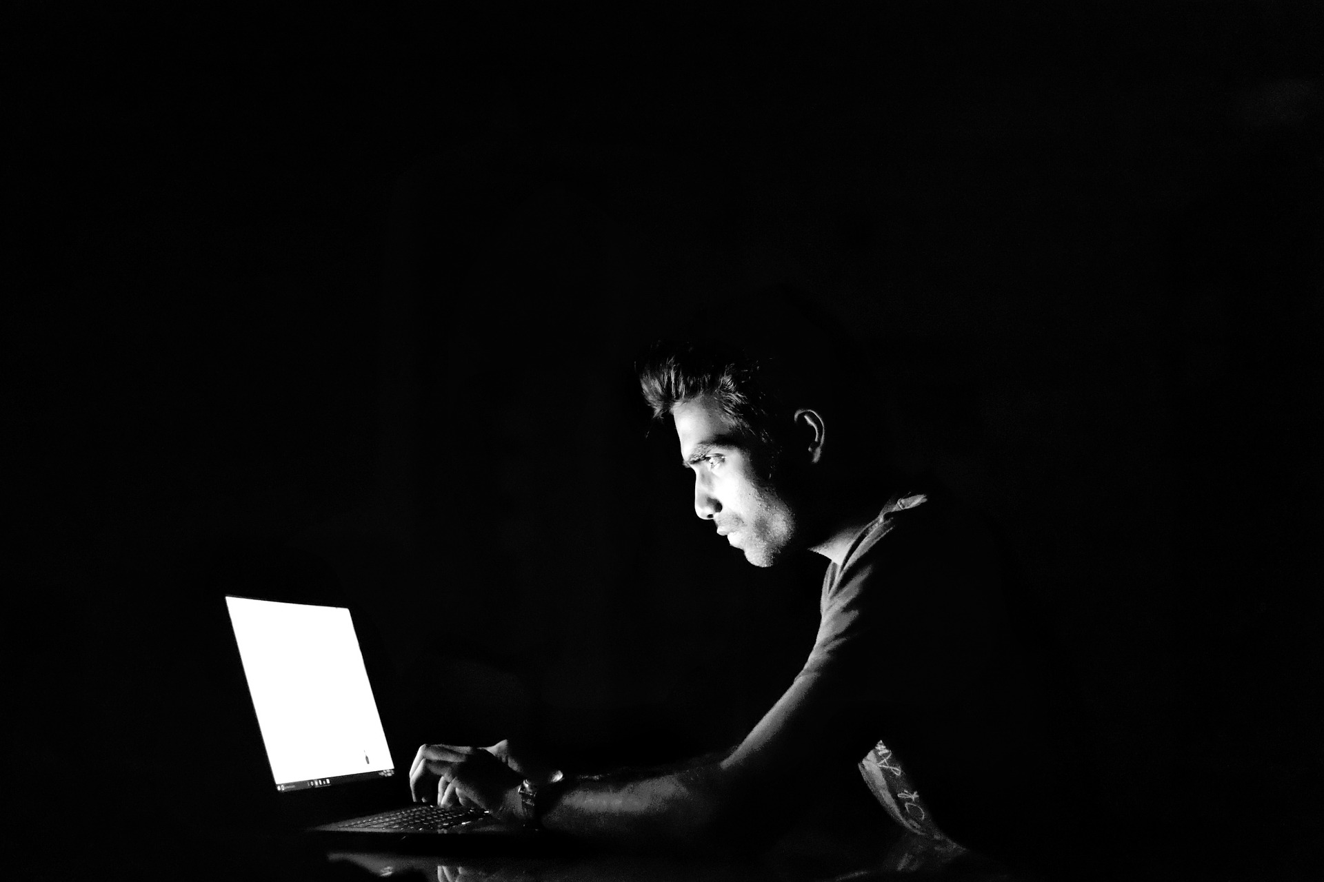 Photo of a man using a laptop
